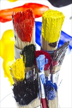 Different types of brushes with colourful acrylic paints