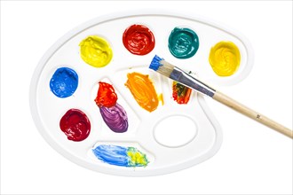 Paint palette with various acrylic paints and a brush