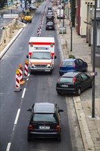 Ambulance driving against the traffic at a construction site during an emergency operation
