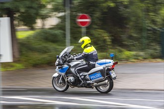 Policeman wearing a yellow helmet on a motorcycle