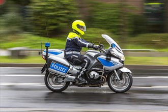 Policeman wearing a yellow helmet on a motorcycle