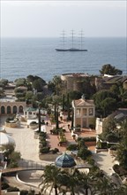 View from the balcony of the Monte Carlo Bay Hotel & Resort over the garden and towards the sea with the large yacht Maltese Falcon