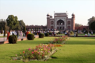 People passing through the entrance gate to the Taj Mahal