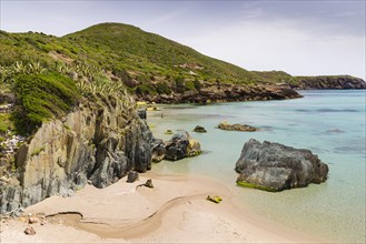 A creek running through the sand of the Spiaggia di Planusartu bay into the sea