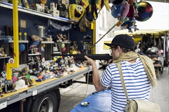 A young man at the shooting gallery at a local fete