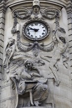 Decorative facade with a clock and figures