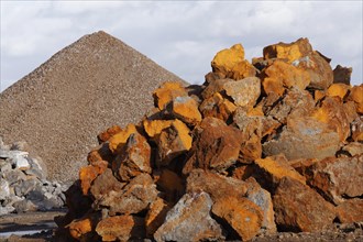 Stack of rusty ferruginous rocks waiting to be recycled