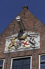 Crest with a lion and a horse on a historic warehouse of the Dutch West India Company