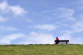 Person sitting in a bench