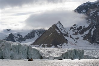 Zodiac inflatable boat during an expedition cruise in front of Samarinbreen Glacier and Tindegga Mountain