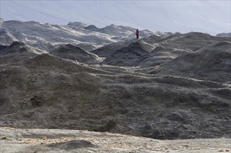 Person standing in a moraine landscape