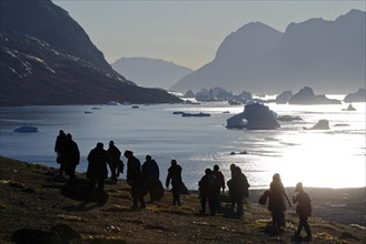 Hikers in front of fjord scenery in Vest Frederiksdal