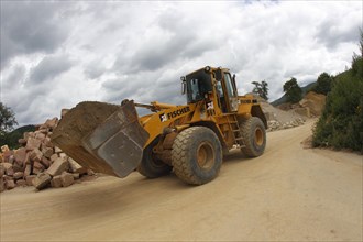 Front end loader in a gravel pit