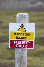 Warning sign 'Asbestos hazard - keep out' at the Stromness whaling station