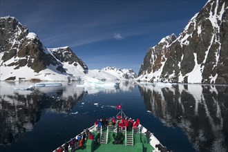 Visitors on the bow of the expedition cruise ship