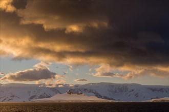 Clouds and glaciated mountains in the Gerlache Strait in the evening light