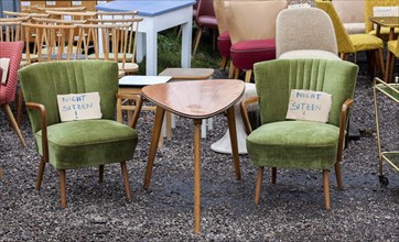 Table and armchairs from the 1960s are offered for sale at a flea market