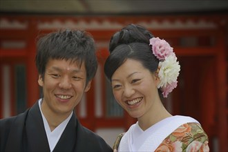 Japanese man and a Japanese woman wearing a kimono for spring with a kimono collar and an updo hairstyle with chrysanthemums