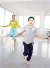 Mother and son skipping rope