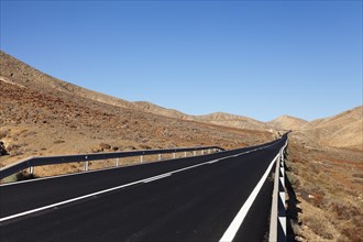 Road through a barren mountain landscape