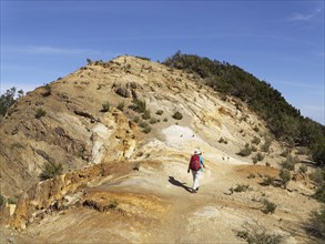 Woman walking through eroded landscape