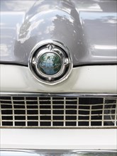 Emblem of a Ford Taunus classic car with a globe