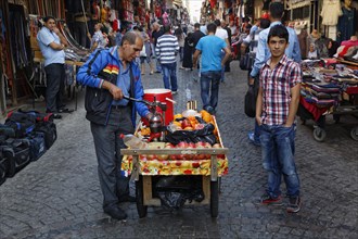 Mobile juice sellers with pomegranates and oranges
