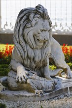 Stone lion with a crocodile in the garden of Dolmabahce Palace
