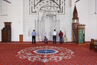 Muslims praying in the prayer room of the Isabey Mosque