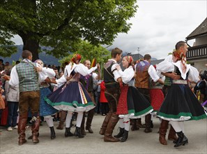 Men and women wearing traditional costumes from the Gailtal valley dancing