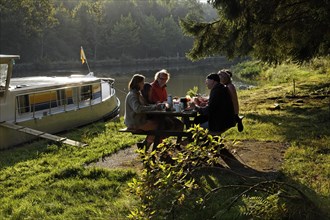Holidaymakers having breakfast on a picnic table