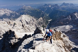 Mountain climbers decending along the Via Ferrata Marino Bianchi climbing route on Mount Cristallo