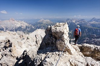 Mountain climber descending the Marino Bianchi climbing route on Monte Cristallo to the summit of Cristallo di Mezzo