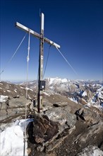 Summit cross of Wilden Kreuzspitze Mountain in the Pfunderer Mountains