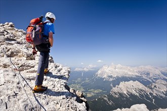 Mountain climber ascending the Via Ferrata Marino Bianchi climbing route on Monte Cristallo
