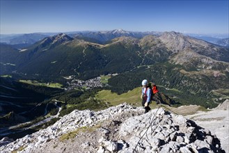 Mountain climber ascending the Via Ferrata Bolver Lugli climbing route on Cima di Vezzana Mountain