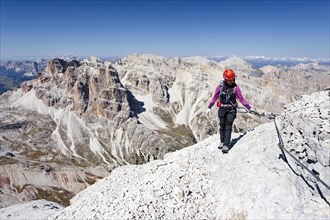 Mountain climber ascending Tofane di Rozes Mountain along the Via Ferrata Giovanni Lipella climbing route