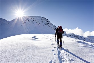 Snowshoe hiker ascending Schwarzhorn Mountain on Jochgrimm