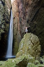 Man standing at the waterfall of Cachoeira da Fumacinha
