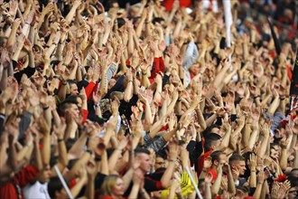 Fans of football club Bayer 04 Leverkusen cheering on their team