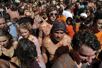 Participants throwing tomatoes at each other during the annual Tomatina festival