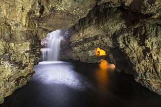 Allt Smoo stream passing through a hole in the ceiling into Smoo Cave limestone cave