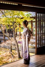 Japanese woman dressed with kimono in the courtyard of O-shoin