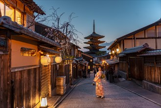 Woman in Kimono posing in an alley