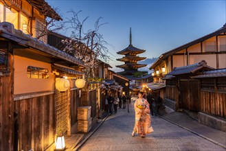 Woman in kimono in a lane