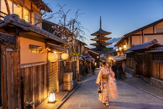 Woman in kimono in a lane