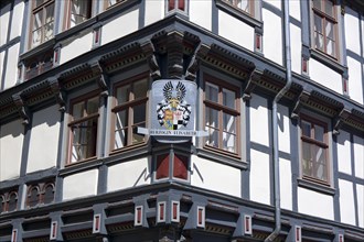 Half-timbered house with a coat of arms
