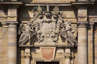 Two angels holding the coat of arms of Prince-Abbot Adalbert von Schleifras above the main entrance of St. Salvator Cathedral of Fulda
