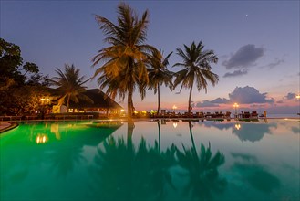 Restaurant and pool area of Paradise Island at dusk