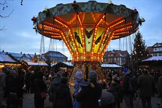 Children's carousel at the Christmas market on Schlossplatz square